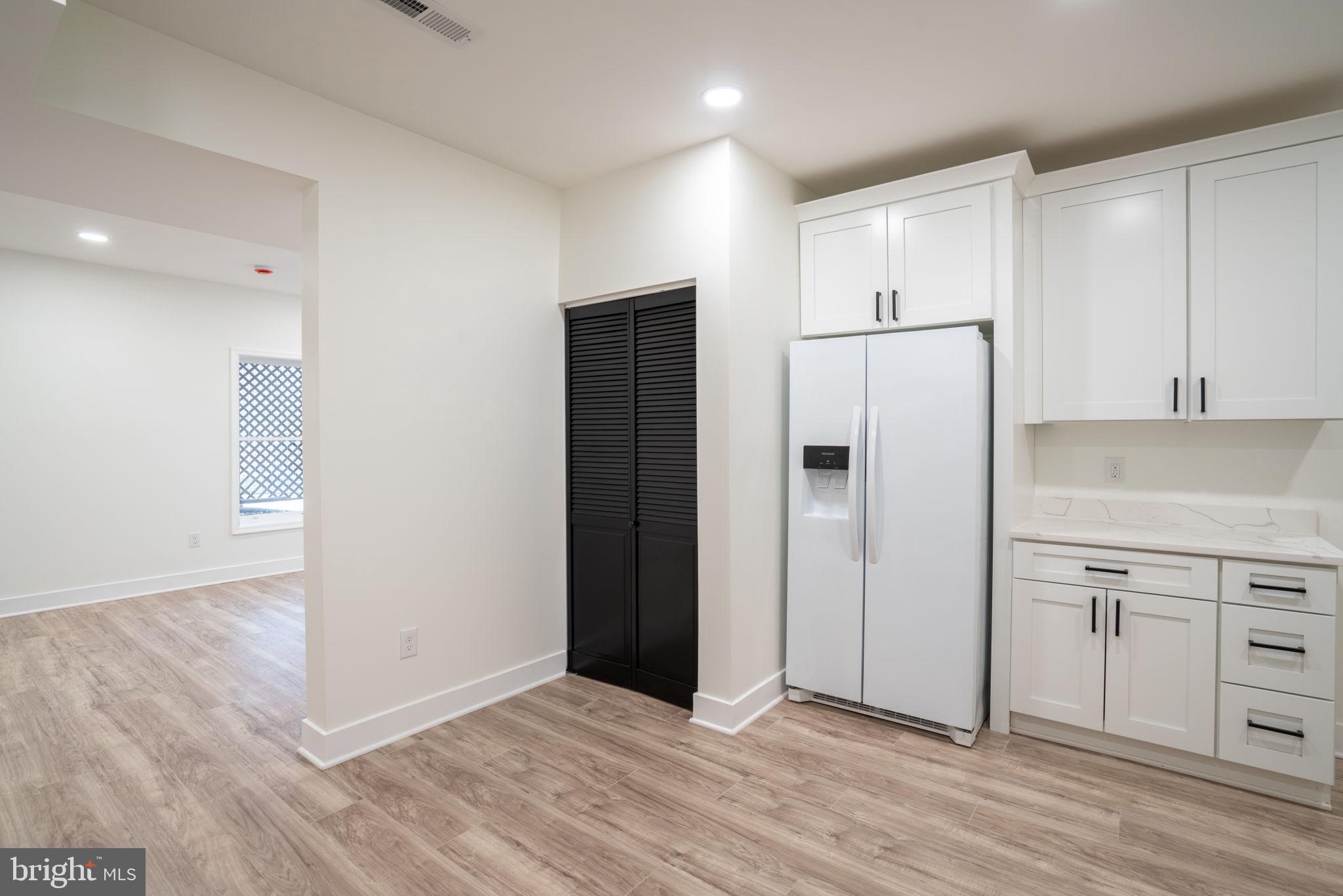 8261 Tinsley Place Culpeper, VA 22701 - Photo 52 of 80 a view of a refrigerator in kitchen and white cabinets