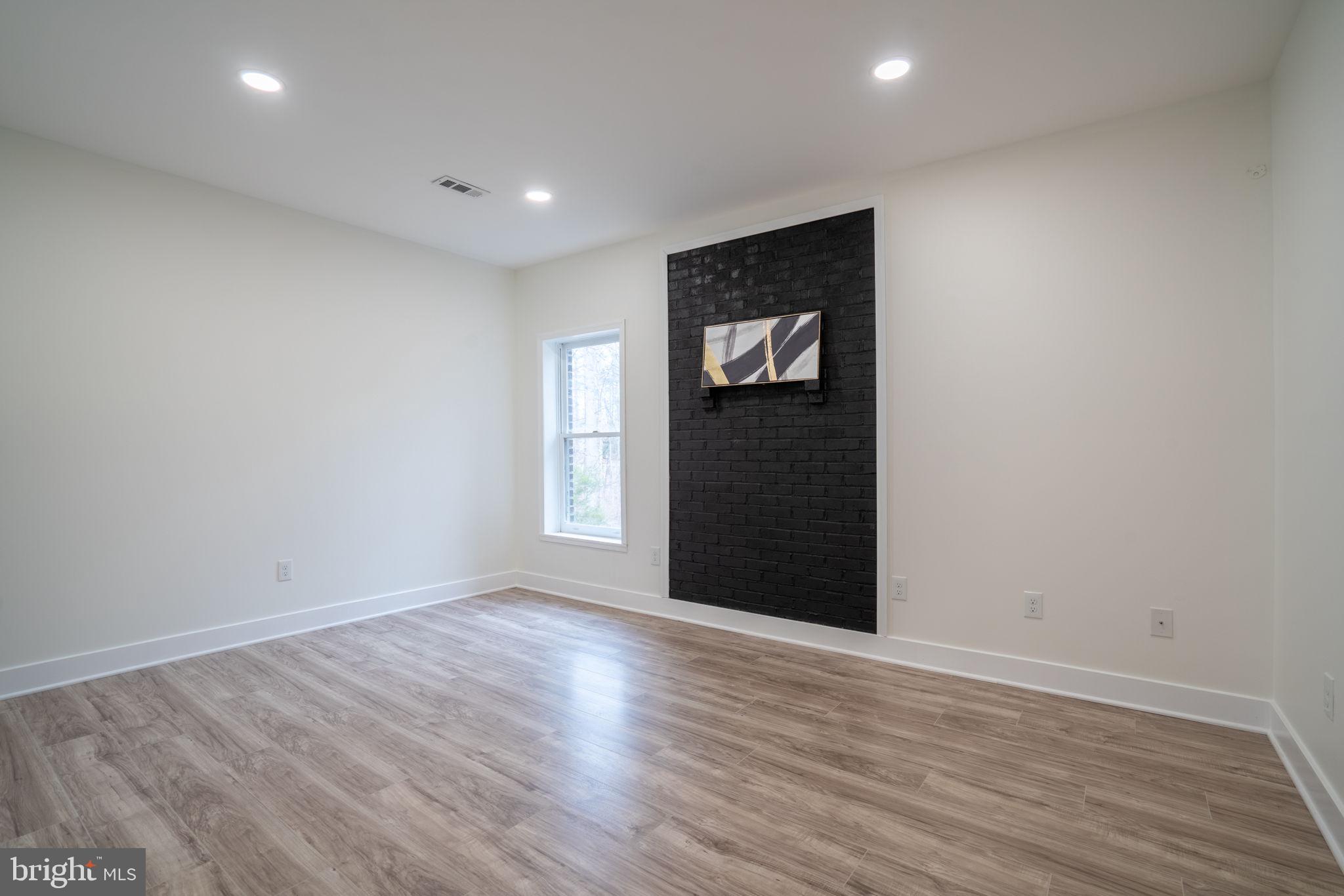 8261 Tinsley Place Culpeper, VA 22701 - Photo 56 of 80 a view of an empty room with wooden floor and closet