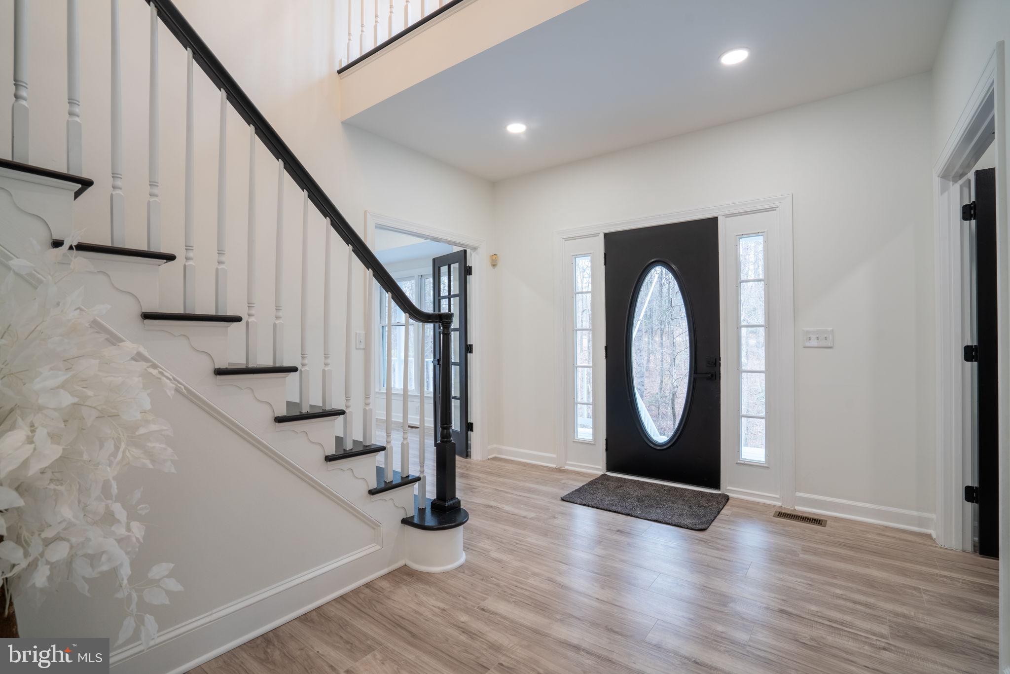 8261 Tinsley Place Culpeper, VA 22701 - Photo 6 of 80 a view of entryway and hall with wooden floor