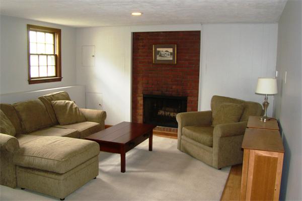 29 Holly Road Reading, MA 01867 - Photo 17 of 23 a living room with furniture and a fireplace