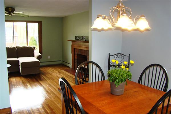 29 Holly Road Reading, MA 01867 - Photo 5 of 23 a dining room with furniture a potted plant and a fireplace