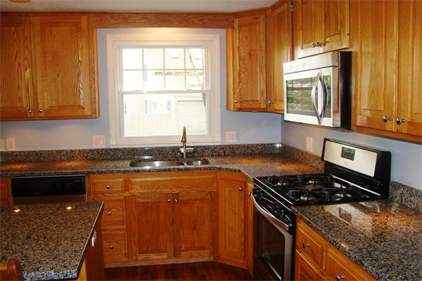 29 Holly Road Reading, MA 01867 - Photo 8 of 23 a kitchen with granite countertop a sink stove and cabinets
