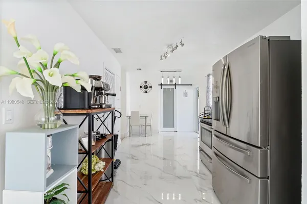 a kitchen with stainless steel appliances a refrigerator and a counter top space
