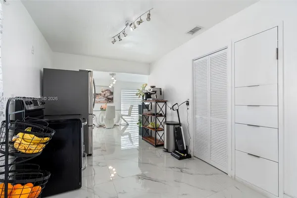 a view of walk in closet with clothes