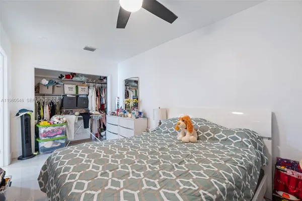 a bed room with a bed and a chair