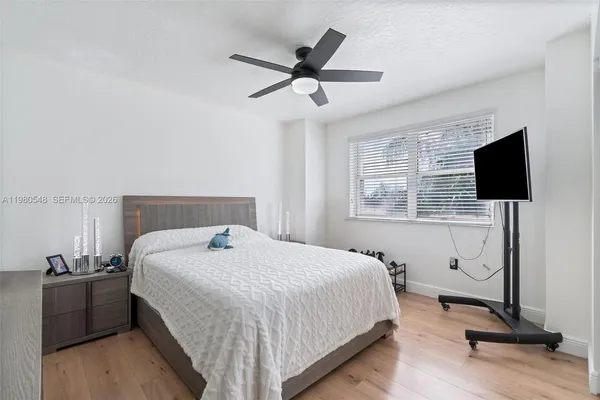 a bedroom with a bed and a flat screen tv