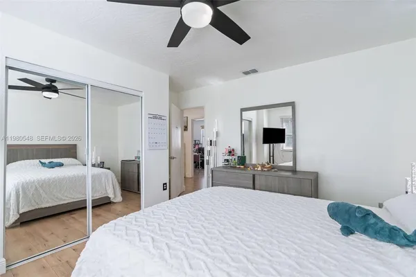 a bedroom with a bed and a large mirror
