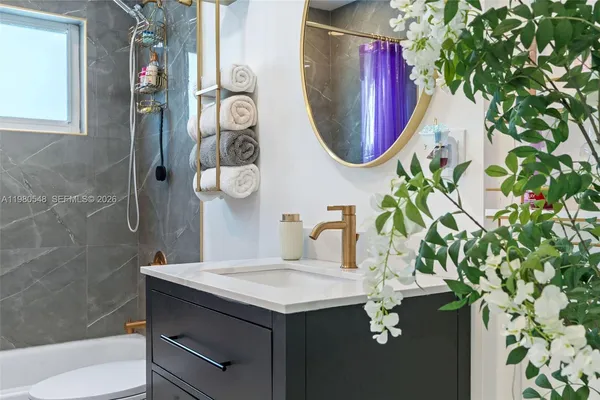 a bathroom with a sink and mirror