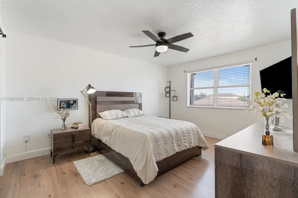 a bedroom with a bed and a flat screen tv