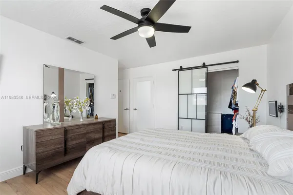a bedroom with a bed and a chandelier