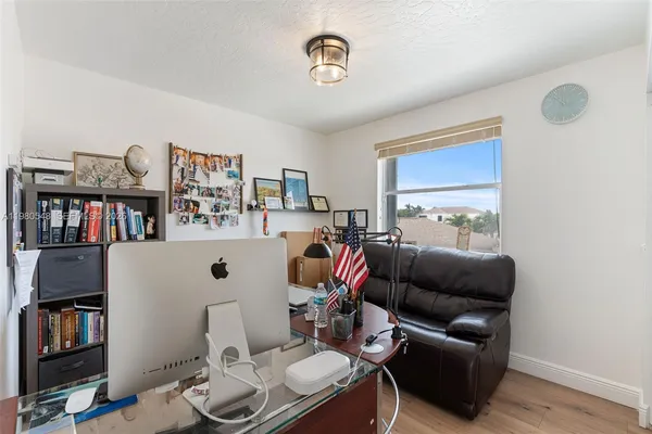 a living room with furniture and a book shelf