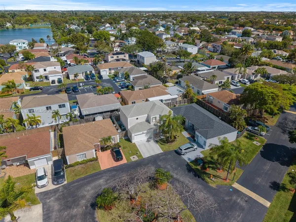an aerial view of residential houses with outdoor space