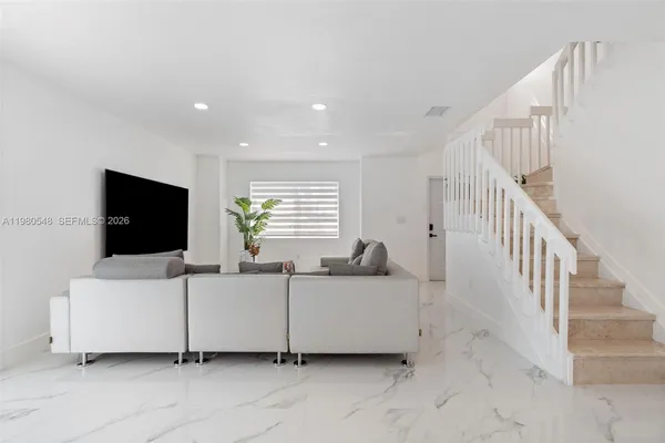a living room with furniture and a flat screen tv