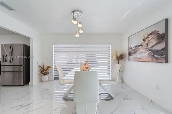 a view of a livingroom with furniture and chandelier