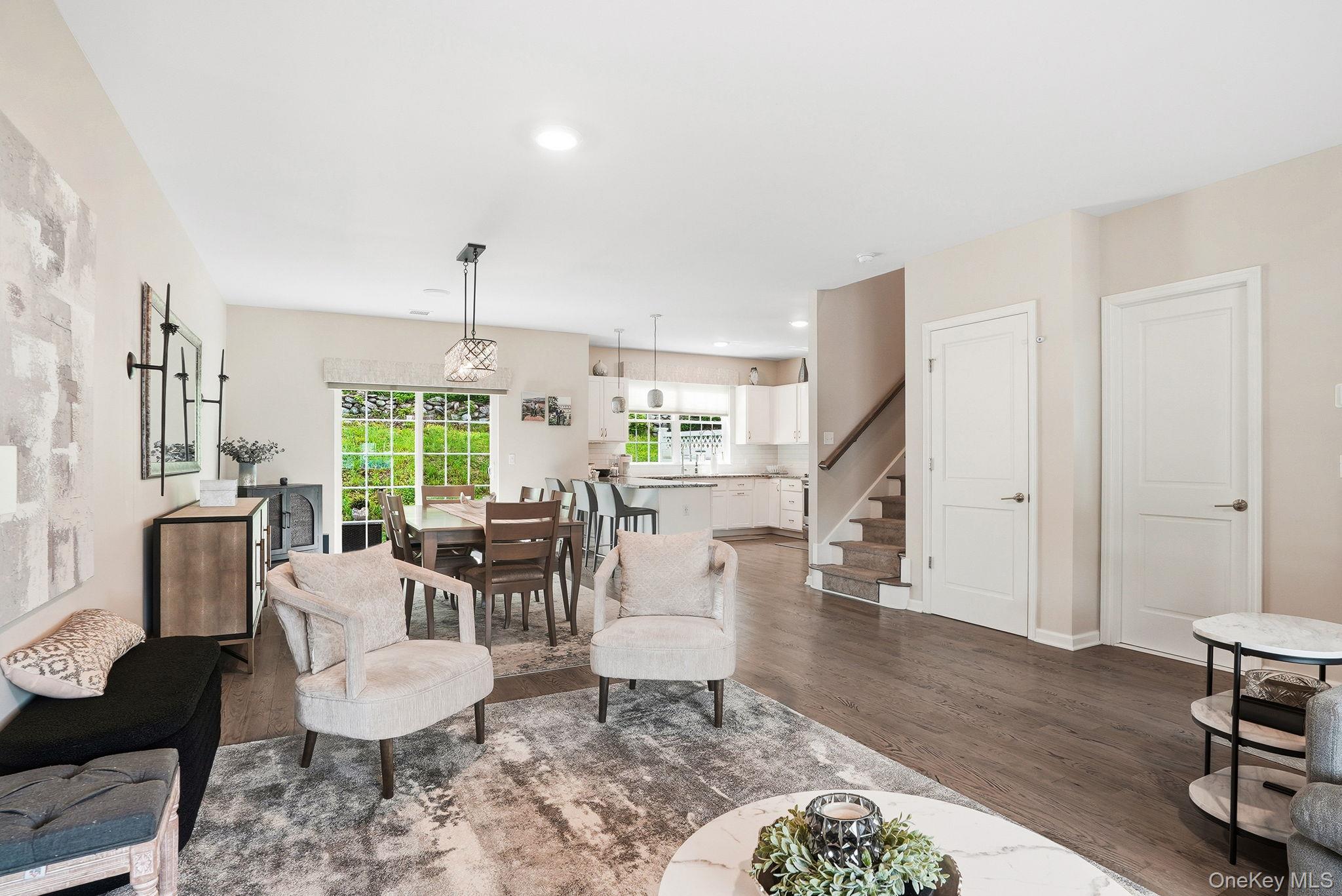 8 Muscoot River Road Granite Springs, NY 10527 - Photo 13 of 40 Open-concept main living area featuring wood-finish flooring, recessed lighting, and a dining space with an ornate chandelier and large window