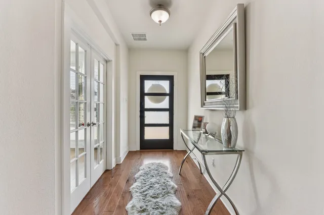 a view of a hallway with a livingroom and a window