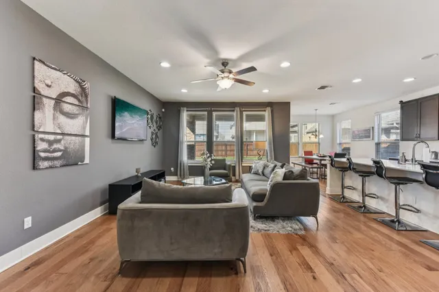 a living room with furniture and wooden floor