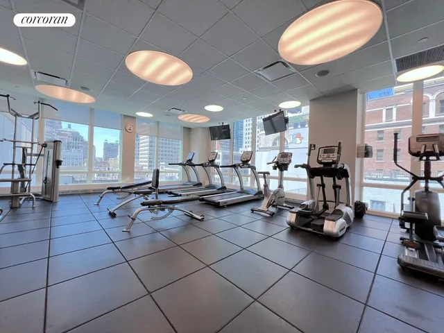 a living room with furniture a wooden floor and window