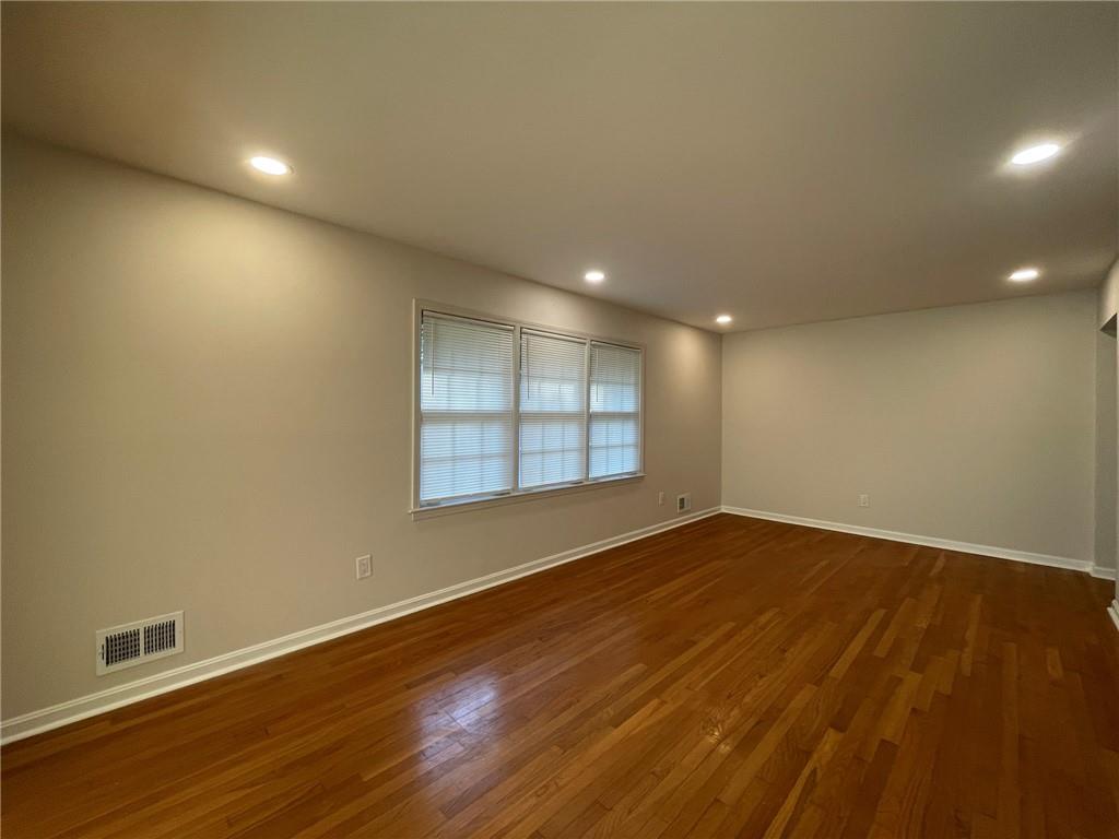 2297 Hylaea Road Tucker, GA 30084 - Photo 5 of 15 an empty room with wooden floor and windows