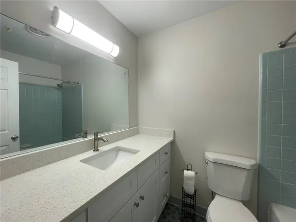 a bathroom with a sink toilet and a mirror