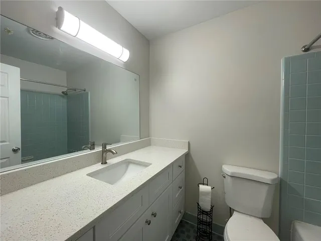 a bathroom with a sink toilet and a mirror