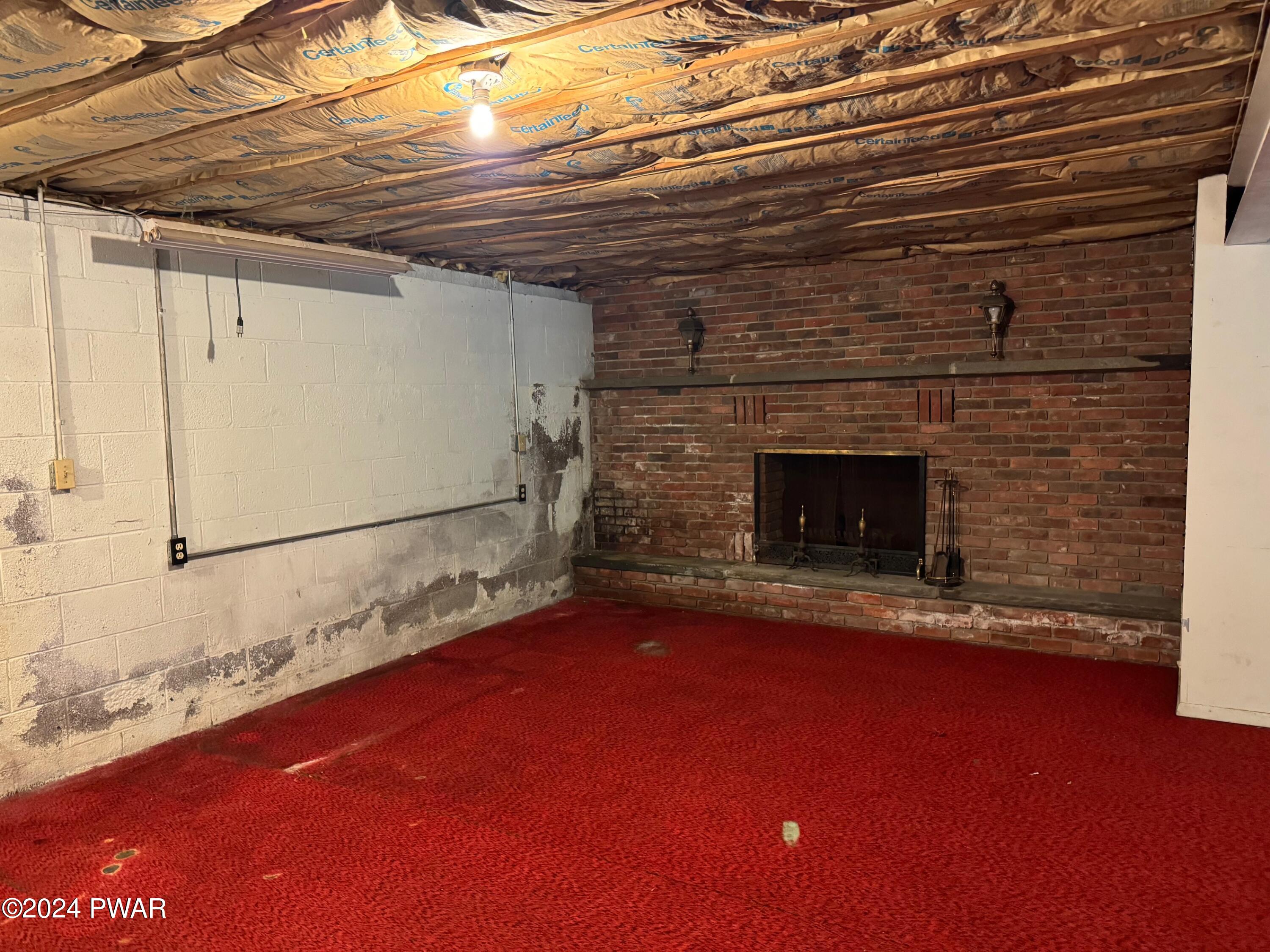 359 Canaan Road Waymart, PA 18472 - Photo 27 of 32 a view of empty room with wooden floor and fireplace