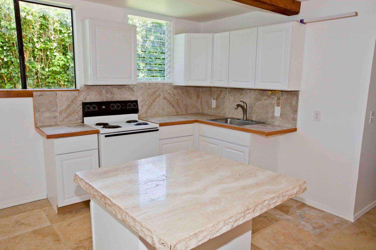 333 West Kuiaha Road Haiku, HI 96708 - Photo 10 of 21 a kitchen with stainless steel appliances a stove a sink and a white cabinets