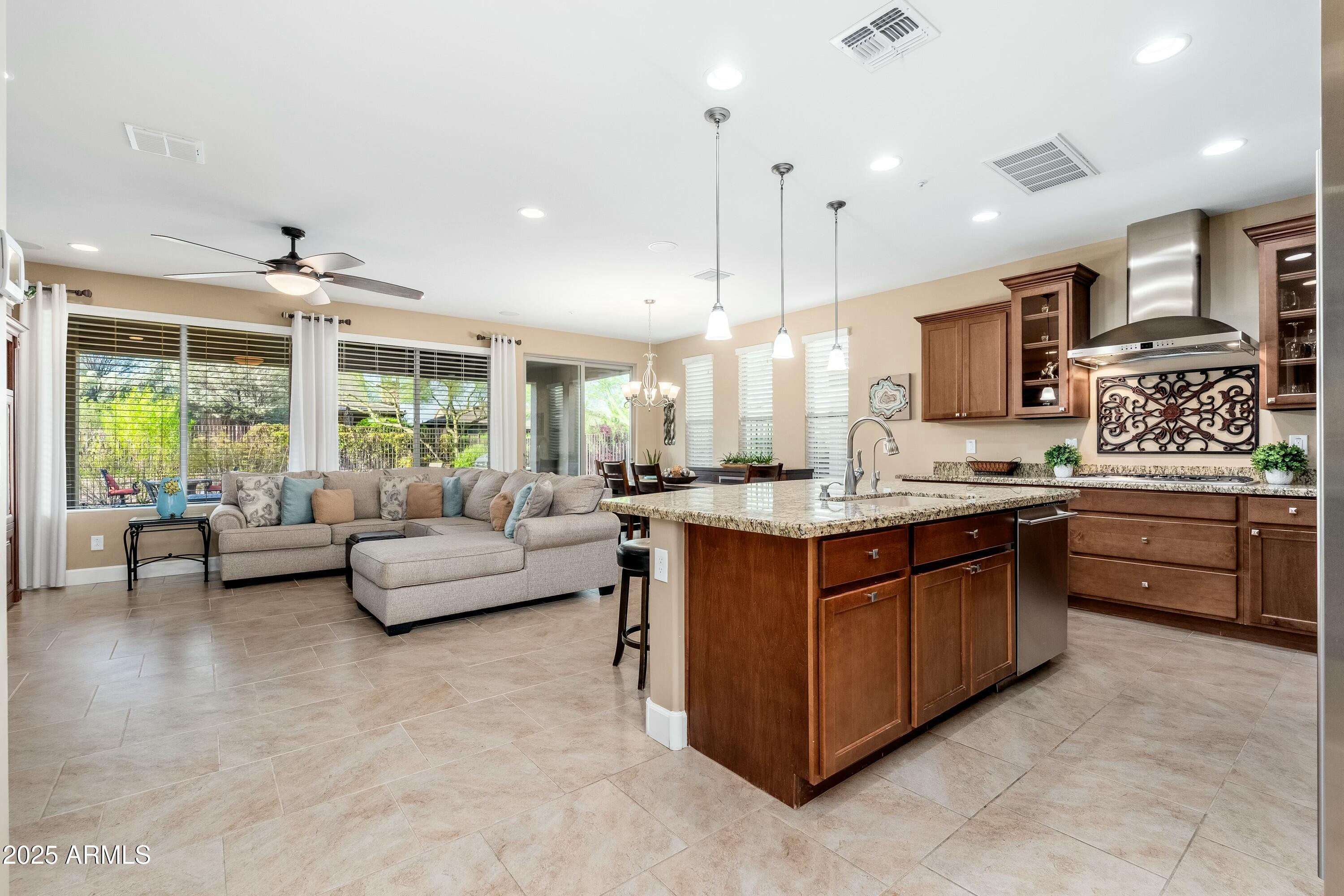 17972 East Silver Sage Lane Rio Verde, AZ 85263 - Photo 1 of 80 a large kitchen with stainless steel appliances kitchen island granite countertop a lot of cabinets a sink and a large window