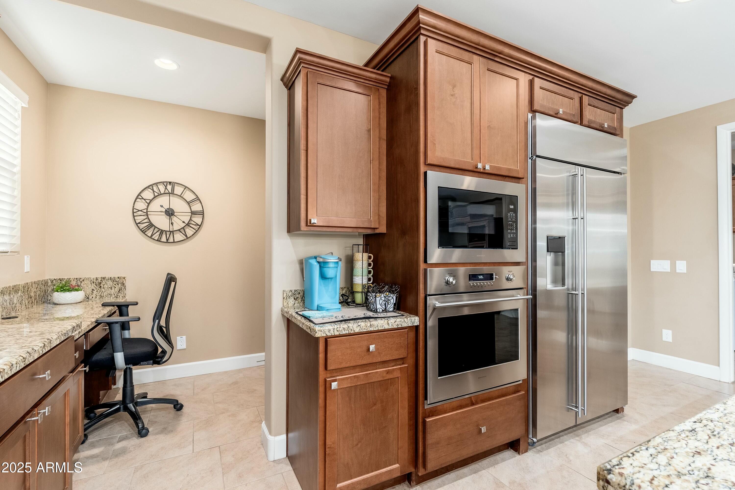 17972 East Silver Sage Lane Rio Verde, AZ 85263 - Photo 11 of 80 a kitchen with stainless steel appliances a stove a refrigerator and a refrigerator with wooden floor