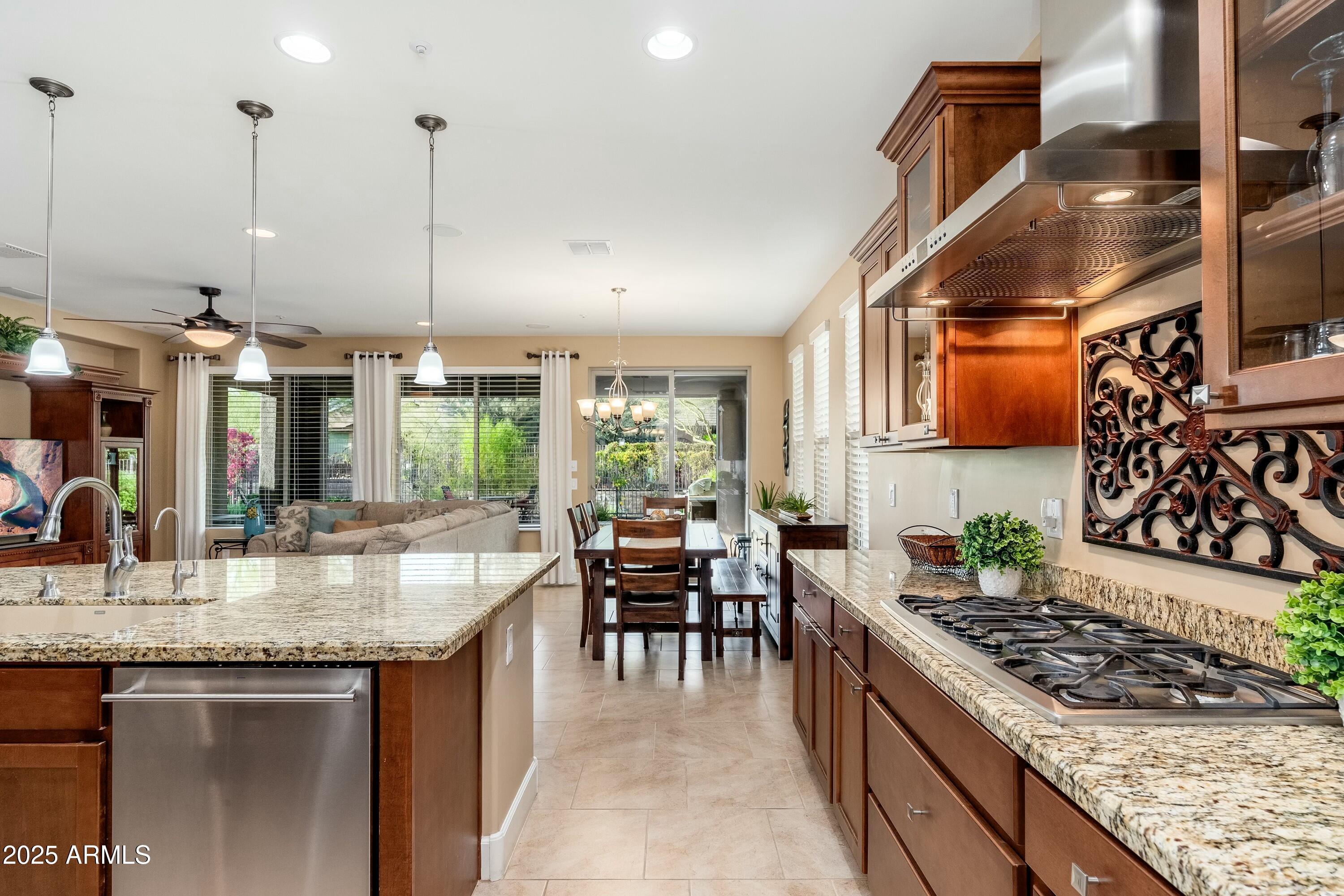 17972 East Silver Sage Lane Rio Verde, AZ 85263 - Photo 12 of 80 a kitchen with stainless steel appliances granite countertop a stove a sink and a wooden floors