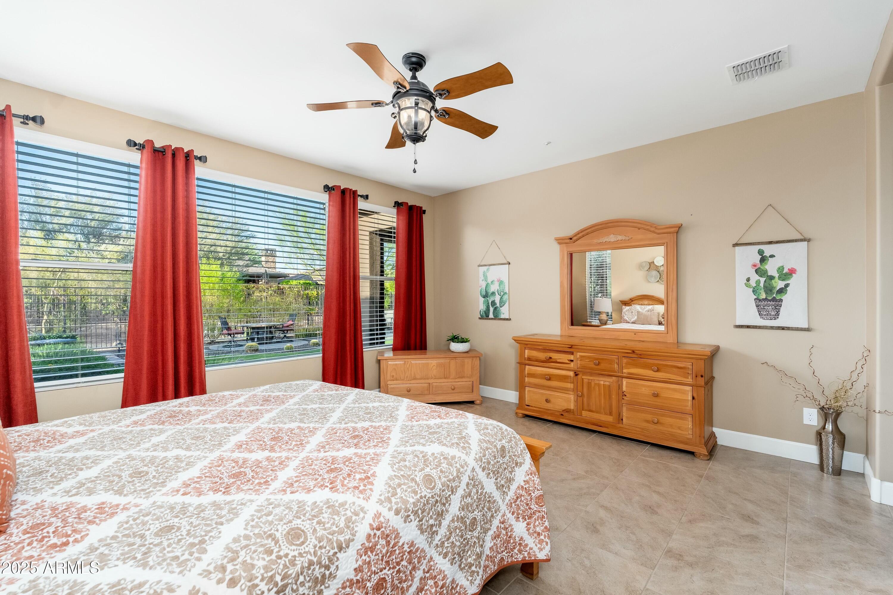 17972 East Silver Sage Lane Rio Verde, AZ 85263 - Photo 18 of 80 a bedroom with a large bed and a dresser