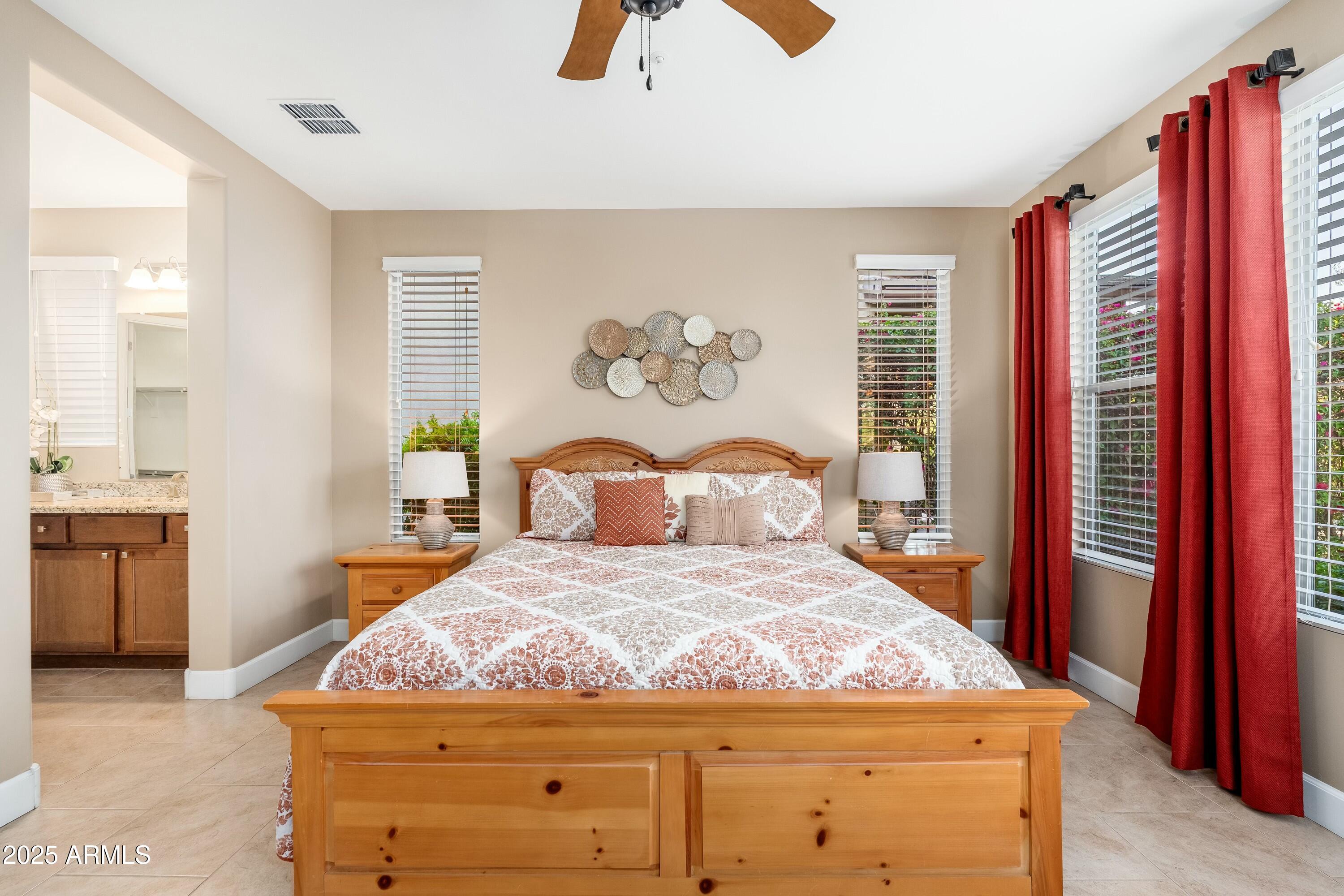 17972 East Silver Sage Lane Rio Verde, AZ 85263 - Photo 19 of 80 a bedroom with a large bed and a chandelier