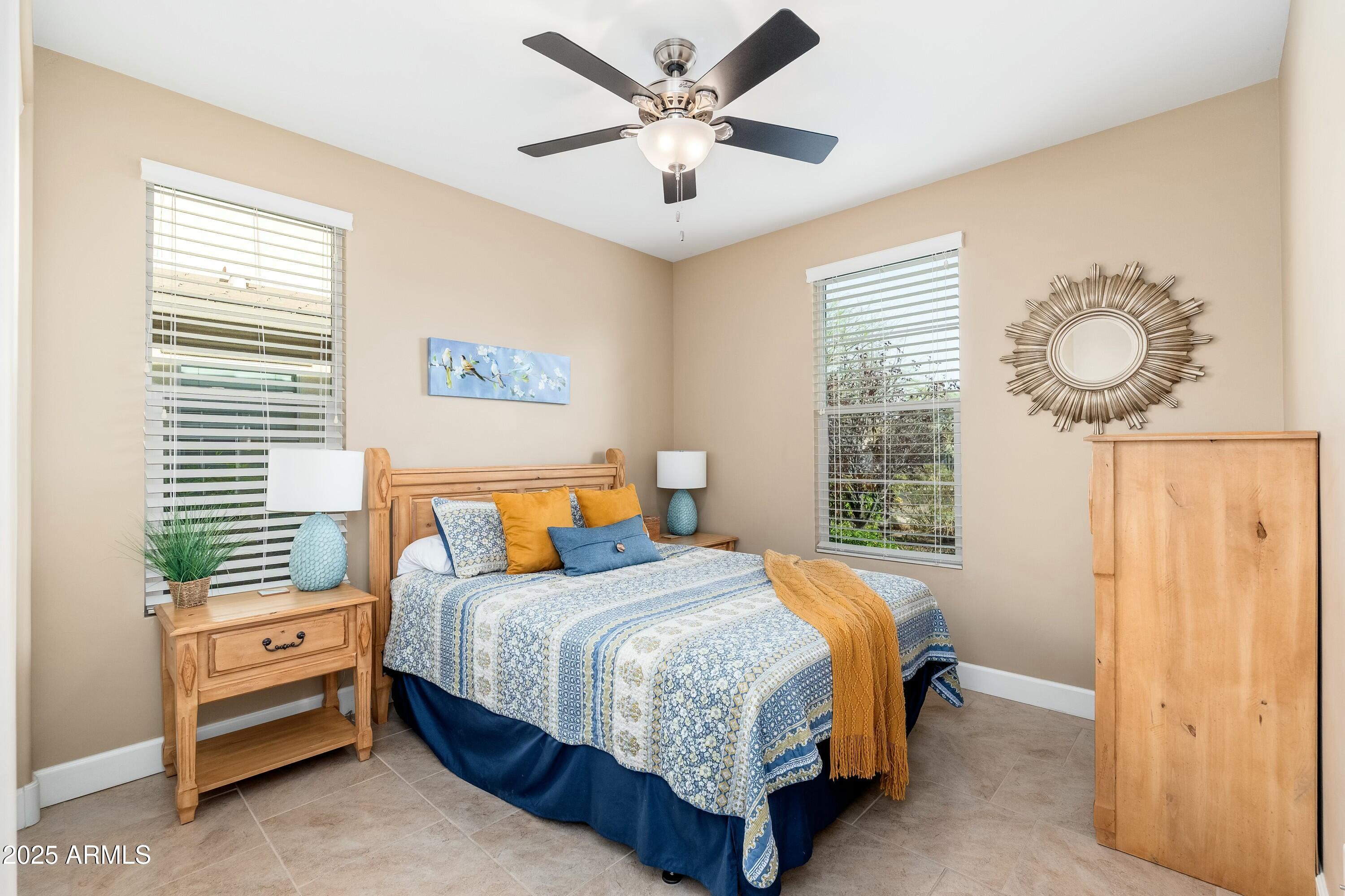 17972 East Silver Sage Lane Rio Verde, AZ 85263 - Photo 22 of 80 a bedroom with a bed and a chandelier