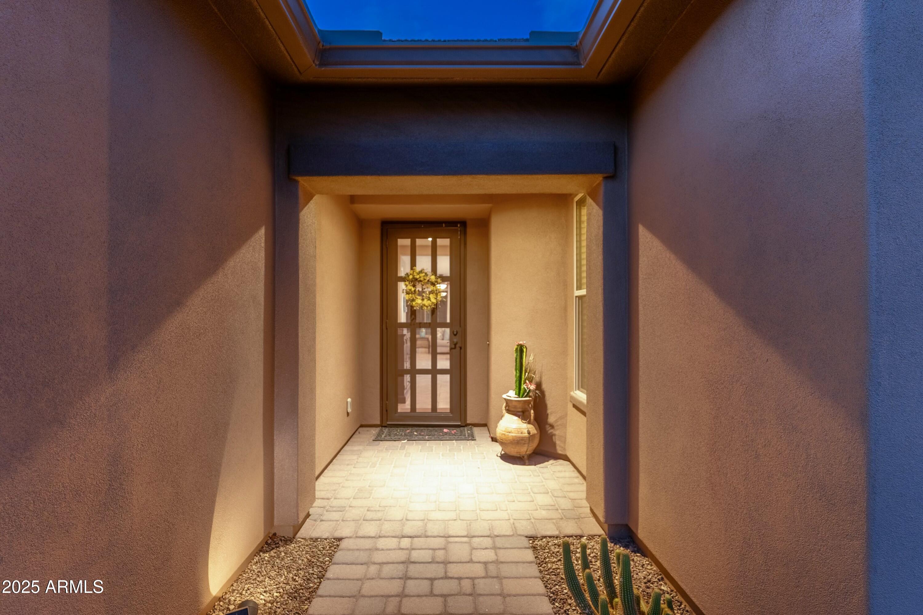 17972 East Silver Sage Lane Rio Verde, AZ 85263 - Photo 3 of 80 a view of a hallway with wooden floor and a bathroom
