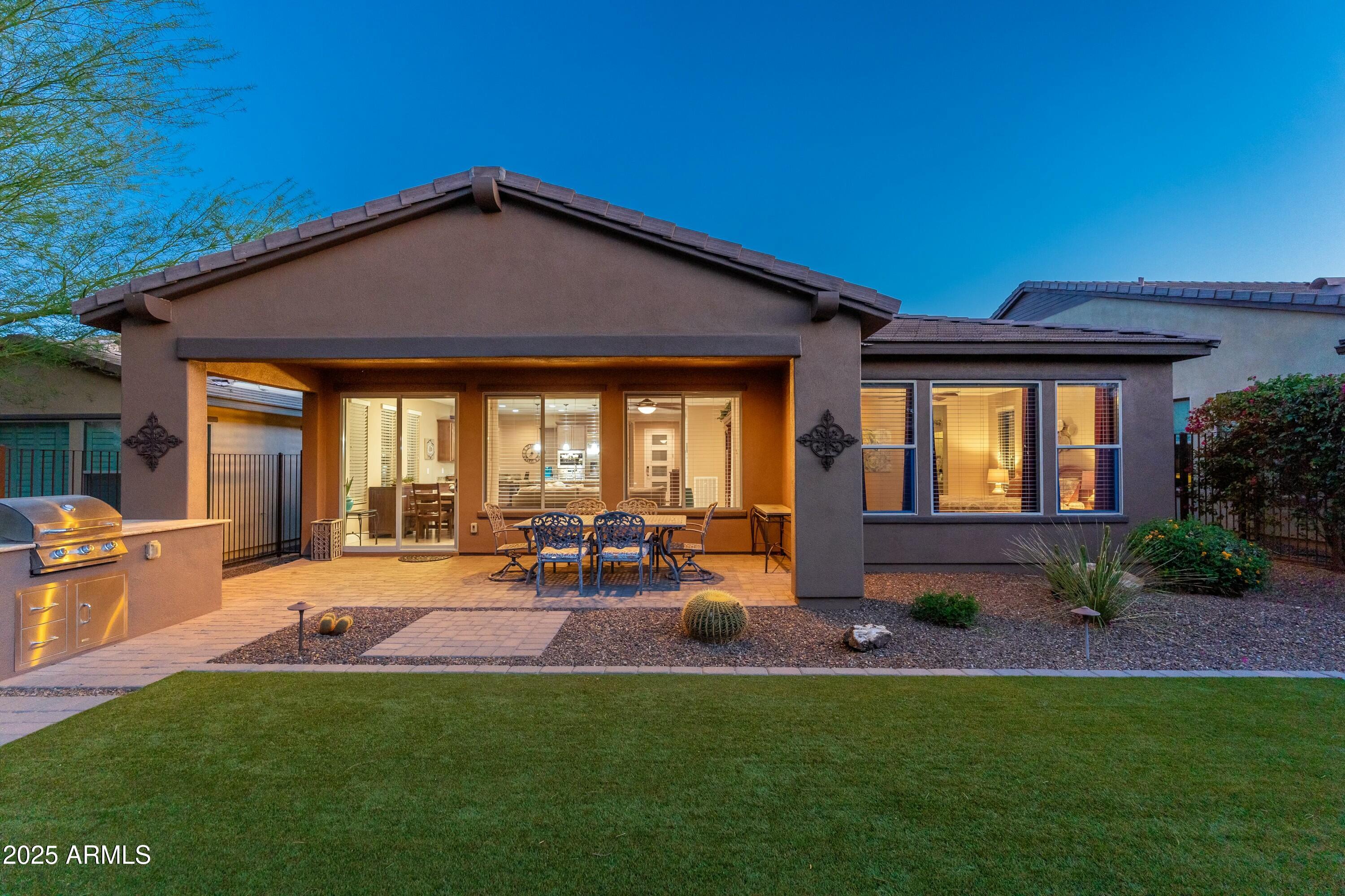 17972 East Silver Sage Lane Rio Verde, AZ 85263 - Photo 39 of 80 a view of a house with backyard sitting area and garden