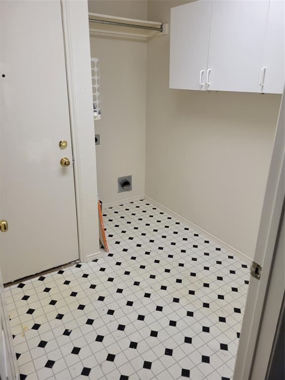 2913 Rush Creek Road McKinney, TX 75072 - Photo 22 of 32 Washroom with cabinets, light tile patterned flooring, and electric dryer hookup