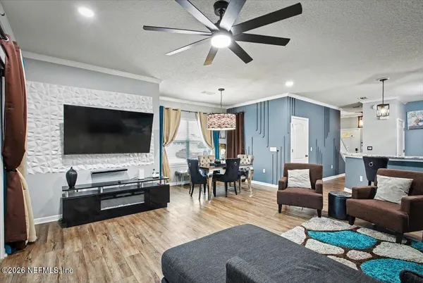 a kitchen with stainless steel appliances kitchen island granite countertop a table chairs and wooden floor