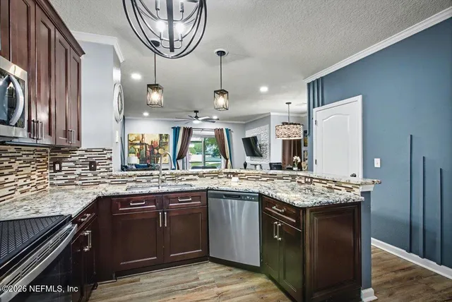 a bathroom with a granite countertop sink vanity mirror and toilet