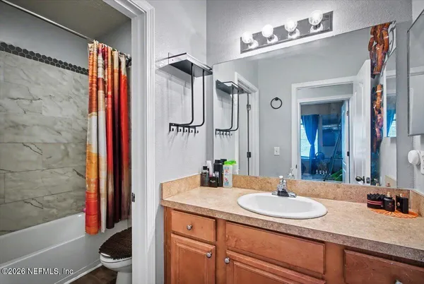a bedroom with a bed window and couch