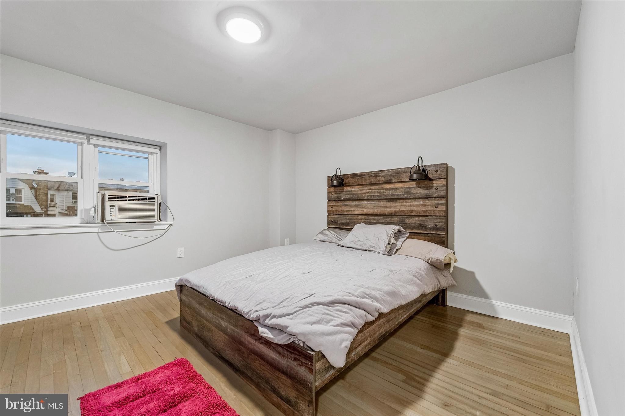 332 Springton Road Upper Darby, PA 19082 - Photo 10 of 15 a bedroom with a bed and wooden floor