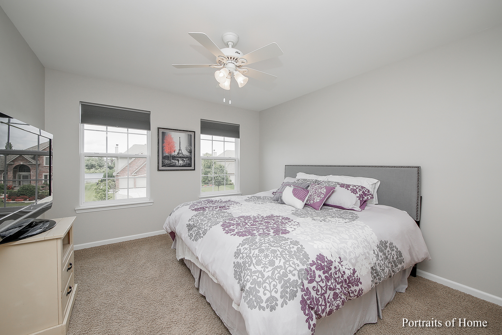 3740 Ryder Court Naperville, IL 60564 - Photo 22 of 25 a bedroom with a bed and a flat tv screen on dresser