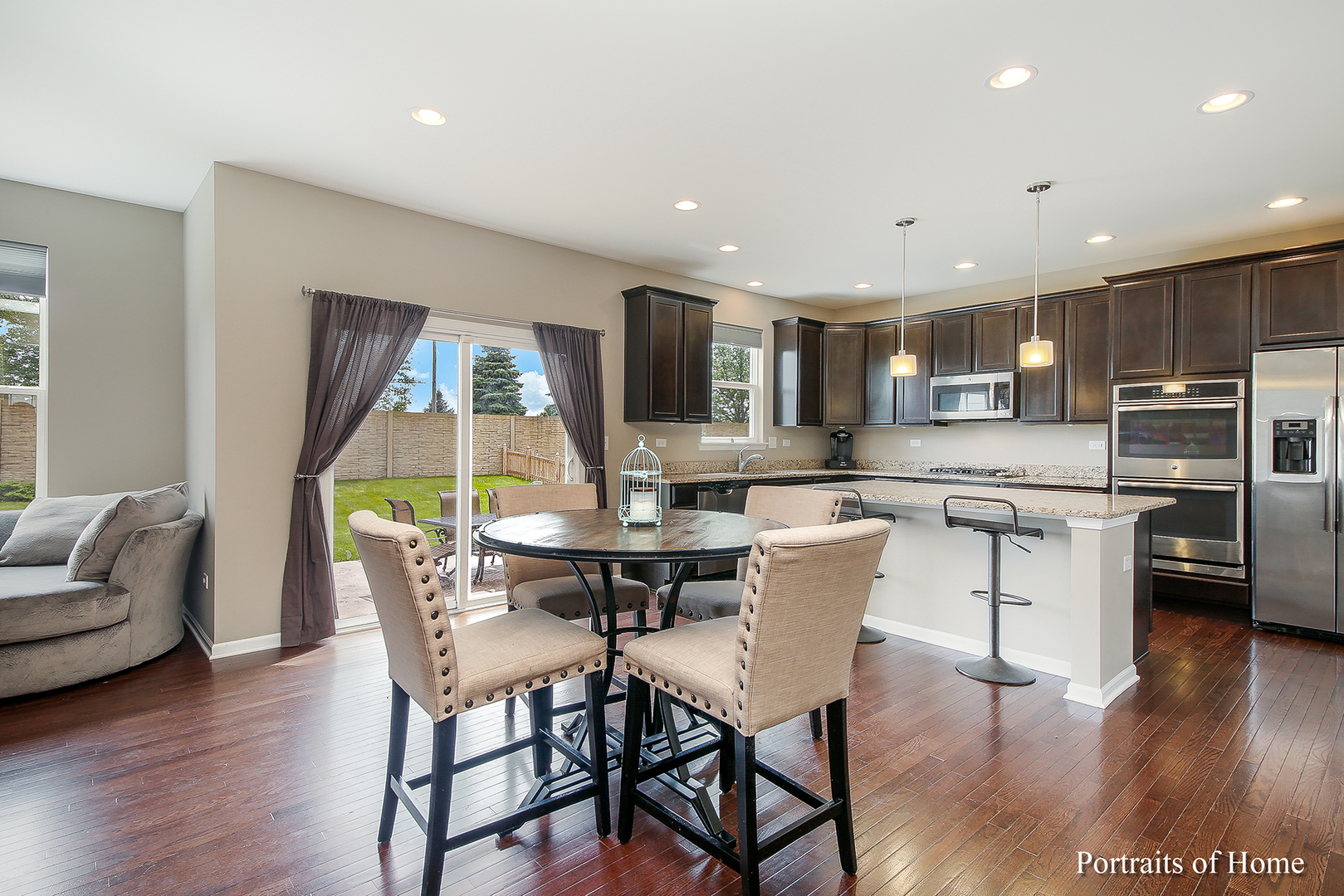 3740 Ryder Court Naperville, IL 60564 - Photo 3 of 25 a dining room with stainless steel appliances kitchen island granite countertop a living room dining room and kitchen view