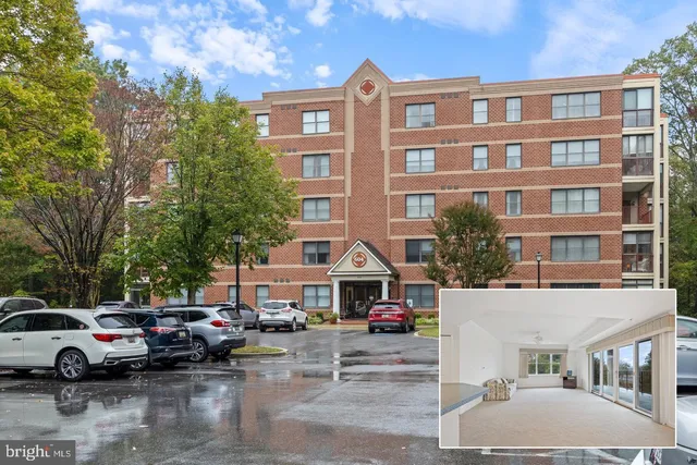 a room with a bed and large windows