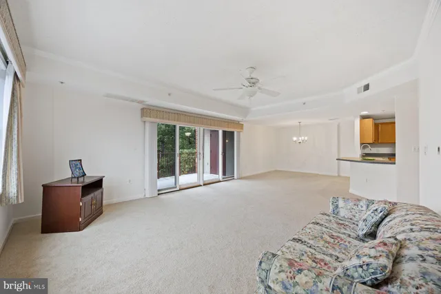 an empty room with a window and a ceiling fan