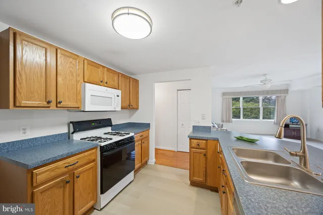 a living room with furniture and a bookshelf