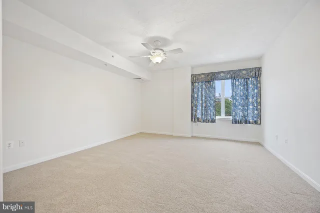 a view of a workspace with furniture and lamp on dresser