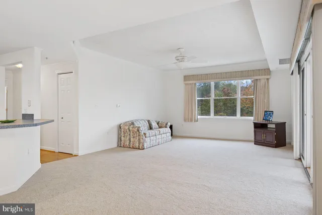a view of an empty room with a ceiling fan