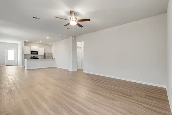 a large kitchen with granite countertop a sink and steel appliances