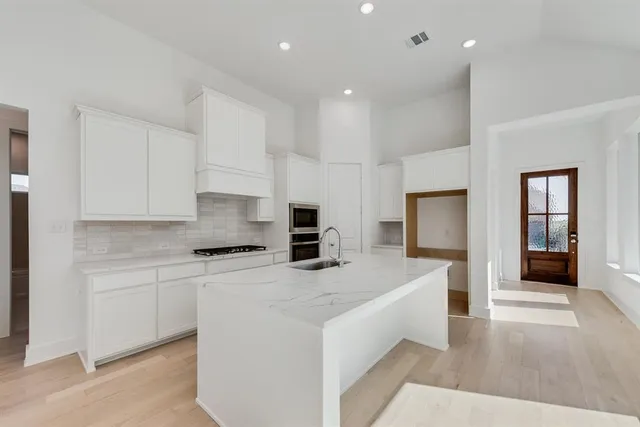 a kitchen with a sink stove and refrigerator