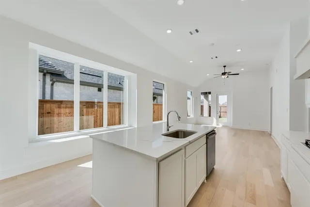 a kitchen with stainless steel appliances a refrigerator sink and stove